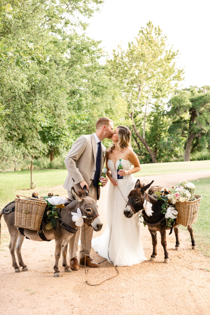 A bride and groom portrait with beer donkeys at Pecan Springs Ranch, one of the best Austin wedding venues.
