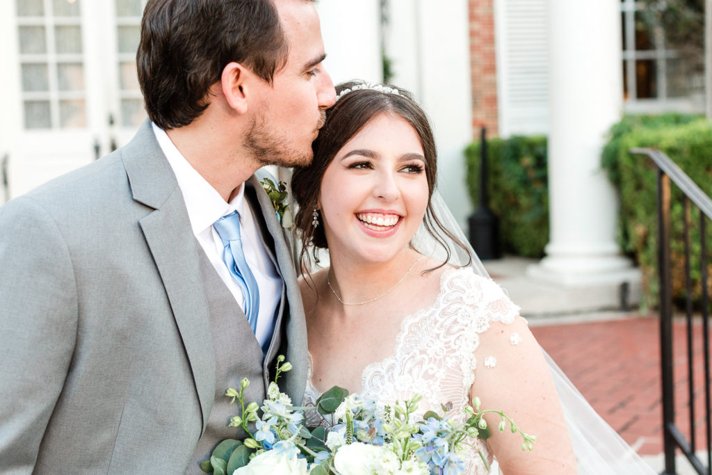 A smiling bride and groom portrait at the Texas Federation of Women's Club (TFWC) Mansion, one of the best austin wedding venues. 