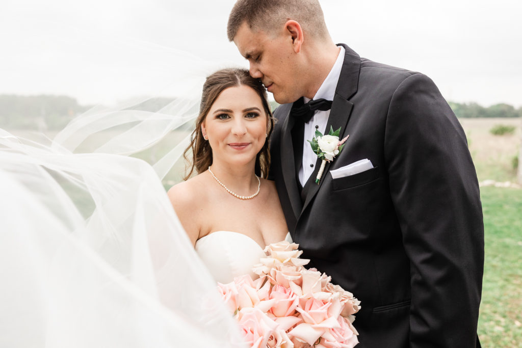 A bride and groom portrait at Stonehouse Villa, one of the top austin wedding venues. 