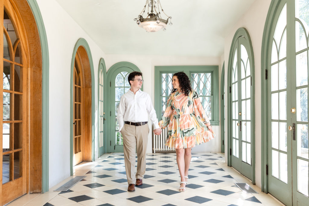 laguna gloria engagement photo outfits couple wearing colorful flowy dress and khakis and white shirt