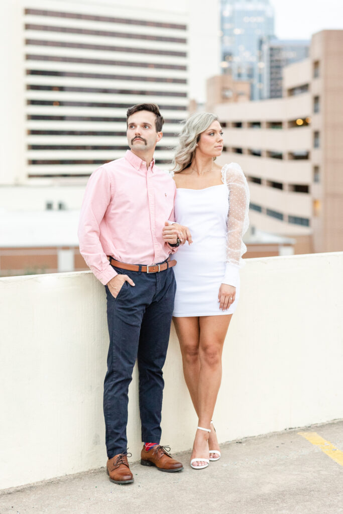 downtown austin parking garage outfits wearing a white dress with puff sleaves and a pink shirt. 